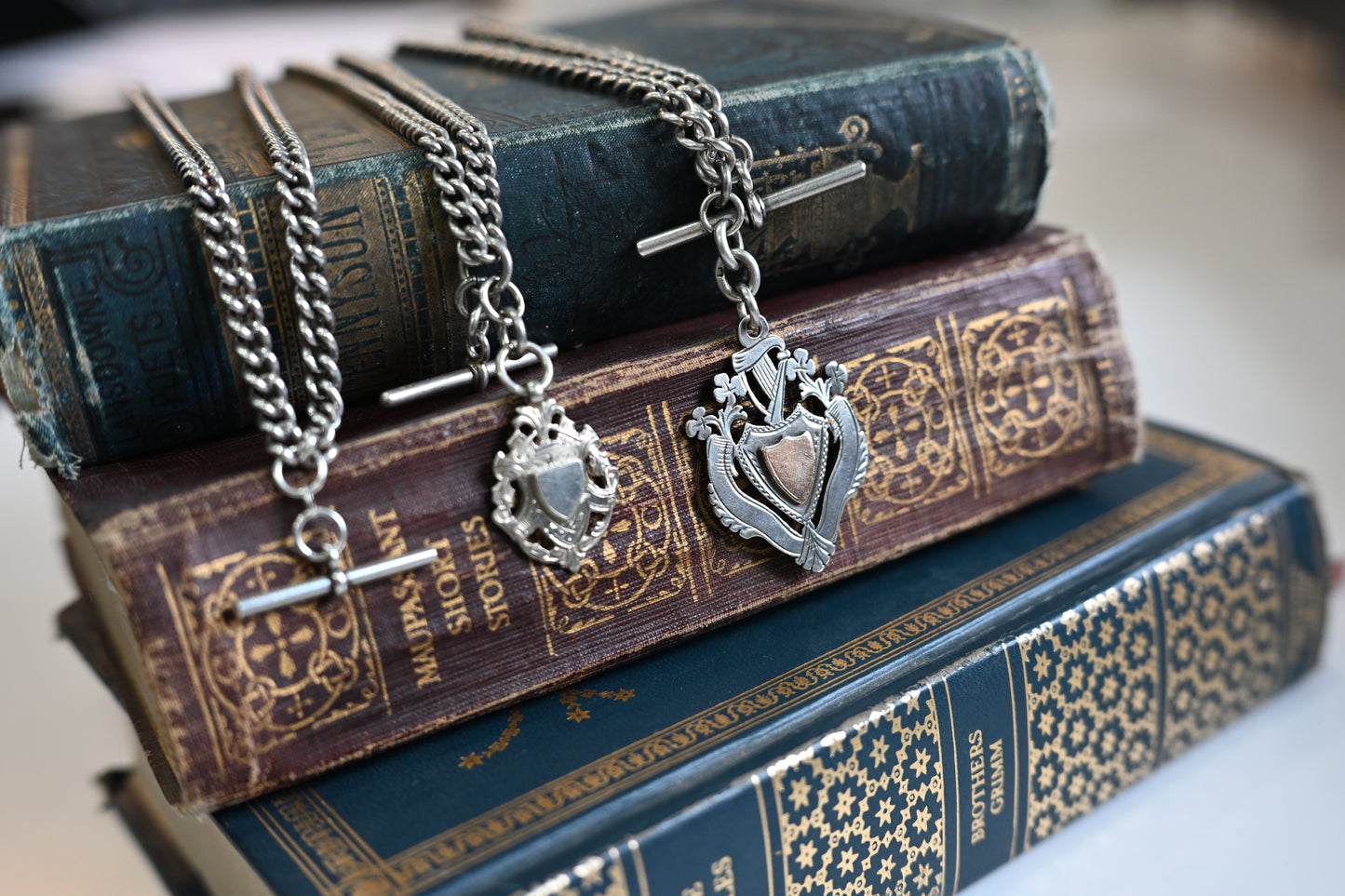 A sterling silver watch chain with T-bar, dog clip clasps and sports jewel, 42.4g